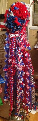 a bunch of red, white and blue streamers on top of a table next to a fan