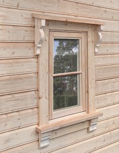 a window on the side of a wooden building