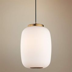 a white light hanging from a ceiling with a black cord in the middle and a beige wall behind it