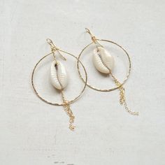 Cowrie shell earrings, Gold chain hoops, Cowrie shell hoop earrings, Beachy earrings Bohemian Gold Hoop Earrings With Dangling Charms, Handmade Gold Hoop Earrings For Vacation, Handmade 14k Gold Filled Beach Earrings, Handmade 14k Gold Filled Earrings For Beach, Beachy Gold Dangle Earrings, Handmade 14k Gold-filled Earrings For Beach, Handmade 14k Gold Filled Jewelry For The Beach, Gold Shell-shaped Hoop Earrings For Beach, Gold Hoop Jewelry For Beach