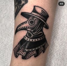 a black and white tattoo with a bird wearing a hat