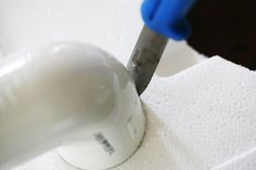 a close up of a toothbrush on top of a toilet paper holder with a blue handle