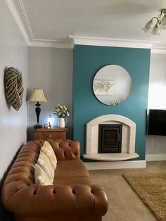 a living room filled with furniture and a fire place next to a wall mounted tv