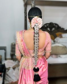 the back of a woman's head wearing a pink sari