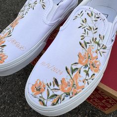 These White Slip On Vans have a soft flower design with gorgeous light orange flower arrangements and lush light green accents. These are the perfect and comfortable gift for wearing on the big day while also enjoying them after the fact while out for brunch and reminiscing on saying "I Do". Add a custom date and initials! The perfect shoes to get personalized. Want this design with light blue flowers? Shop here: https://bit.ly/4bOl0BU We source each pair of blank shoes BRAND NEW directly from V White Slip-on Wedding Shoes, Spring White Slip-on Wedding Shoes, Custom Low-top Sneakers For Wedding, White Lace Wedding Vans, Orange Flower Arrangements, Wedding Low-top Sneakers With Floral Embroidery, White Low-top Sneakers With Floral Embroidery, Custom Slip On Vans, White Floral Embroidered Low-top Sneakers