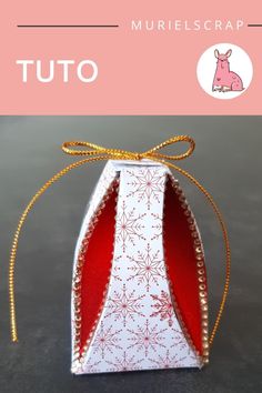 an origami box with a ribbon tied around it and the words tuto on top