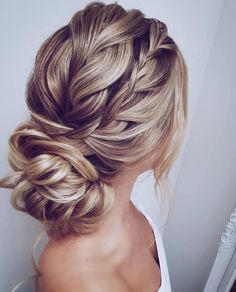 a woman with blonde hair in a braid updo