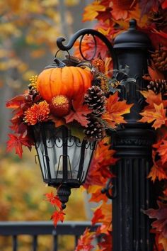 a lamp post decorated with fall leaves and pumpkins