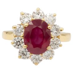 18 kt yellow gold Princess Diana ring with a flower shaped design featuring a center 3.50 ct ruby surrounded by 1.50 cts tw of round diamonds. Diana M. is a leading supplier of top-quality fine jewelry for over 35 years. Diana M is one-stop shop for all your jewelry shopping, carrying line of diamond rings, earrings, bracelets, necklaces, and other fine jewelry. We create our jewelry from gemstones and diamonds of the highest quality (GIA certified) as well as the highest quality of gold and pla Princess Diana Jewelry, Princess Diana Ring, Diana Ring, Princesa Diana, Jewelry Shopping, Princess Diana, Shape Design, Flower Shape, A Flower