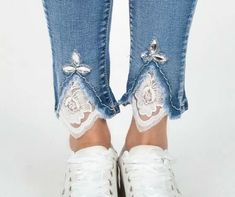 the legs and ankles of a woman wearing white shoes with laces on them,