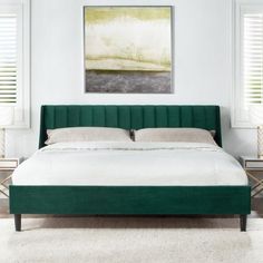 a green bed frame with white sheets and pillows in a bright room, along with two side tables