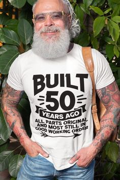 a man with glasses and a beard wearing a t - shirt that says the legend has retired