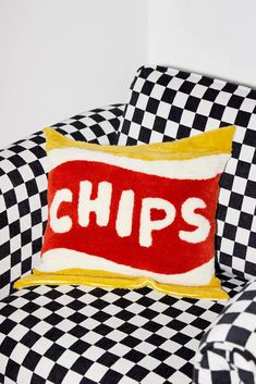 a black and white checkered chair with a red pillow that says chips on it