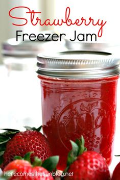 strawberry freezer jam in a mason jar with fresh strawberries on the side and text overlay