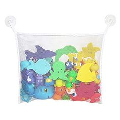 a white mesh bag filled with lots of colorful stuffed animals on top of a white wall