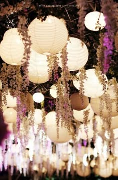 a bunch of paper lanterns hanging from the ceiling with words above them that read, being hospitalable is a way of life