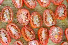 sliced tomatoes on a cutting board with seasoning