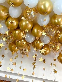 gold and white balloons with stars hanging from the ceiling