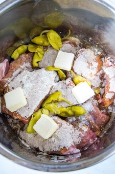 some meat and cheese are in a pot