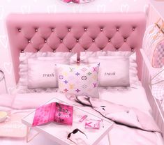 a bed with pink headboard and pillows on top of it next to a table