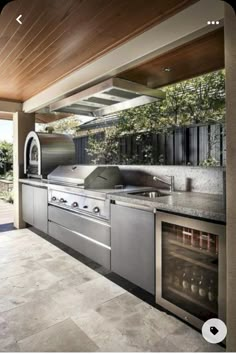 an outdoor kitchen with stainless steel appliances