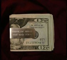 one hundred dollar bill with a metal bar attached to it