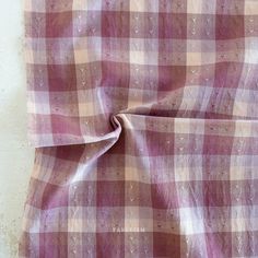 a pink and white checkered fabric on a wall