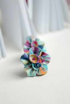 a colorful flower ring sitting on top of a white table