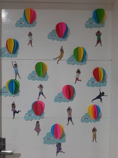 there are many colorful hot air balloons on the wall