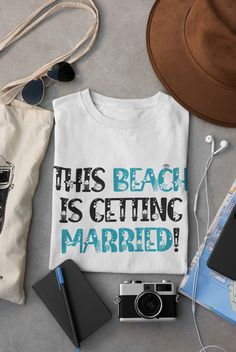 this beach is getting married t - shirt with sunglasses, camera and other items