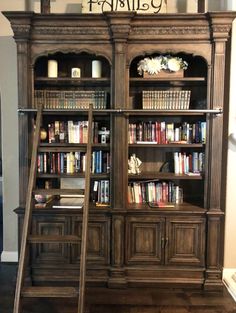 an old bookcase with some books on it and a ladder in front of it