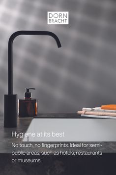 a black faucet sitting on top of a counter next to a sink