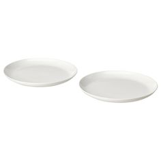 two white plates sitting next to each other