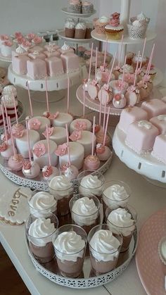 a table topped with cakes and cupcakes covered in frosting