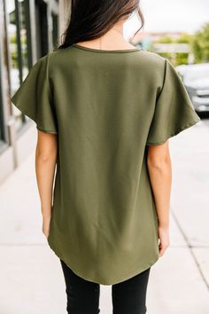 This classic top will be your guide through transitioning from work to dinner! It's so easy to dress up or down! Those ruffled sleeves are precious and this top will style so easily with shorts, pants, or skirts! V-neckline Short flutter sleeves Classic fit Minimal stretch Cindy is wearing the small. Olive Green Top, Shorts Pants, Green Top, Ruffled Sleeves, Model Fits, Green Tops, Flutter Sleeve, Spring Summer Fashion, Spring Fashion