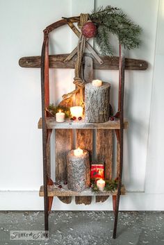 a wooden shelf with candles on top of it