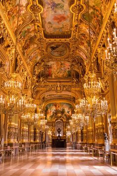 an ornate room with chandeliers and paintings on the walls