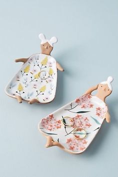 two ceramic figurines in the shape of animals