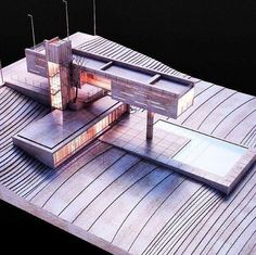 an architectural model of a building on top of a wooden platform