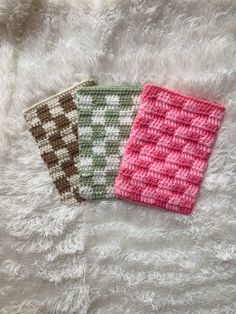 two crocheted coasters sitting on top of a white furnishing covered floor