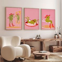 three paintings hang on the wall above a white chair and coffee table in a living room