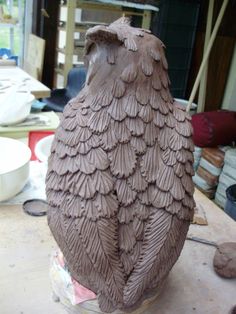 a clay owl sitting on top of a table