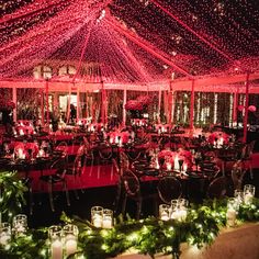 the inside of a tent decorated with christmas lights