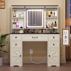 a bathroom vanity with lighted mirror and drawers