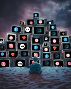 a person sitting on the ground in front of a pile of televisions with icons all over them