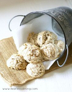 a bucket full of cookies sitting on top of a table next to a cloth napkin