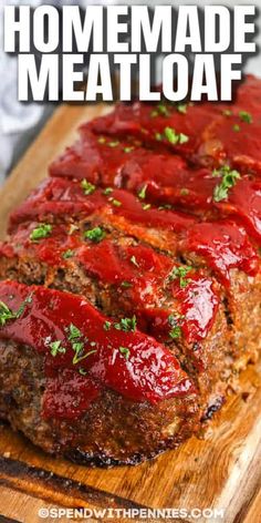 meatloaf on a cutting board with ketchup and green garnish