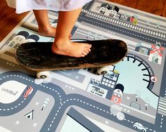 a person standing on top of a skateboard in front of a map floor mat