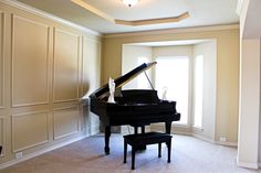 an empty room with a grand piano in it