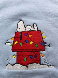 the snoopy house is decorated with christmas lights and peanuts on it's roof